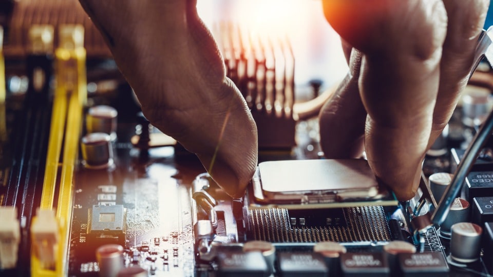 person placing chip into computer